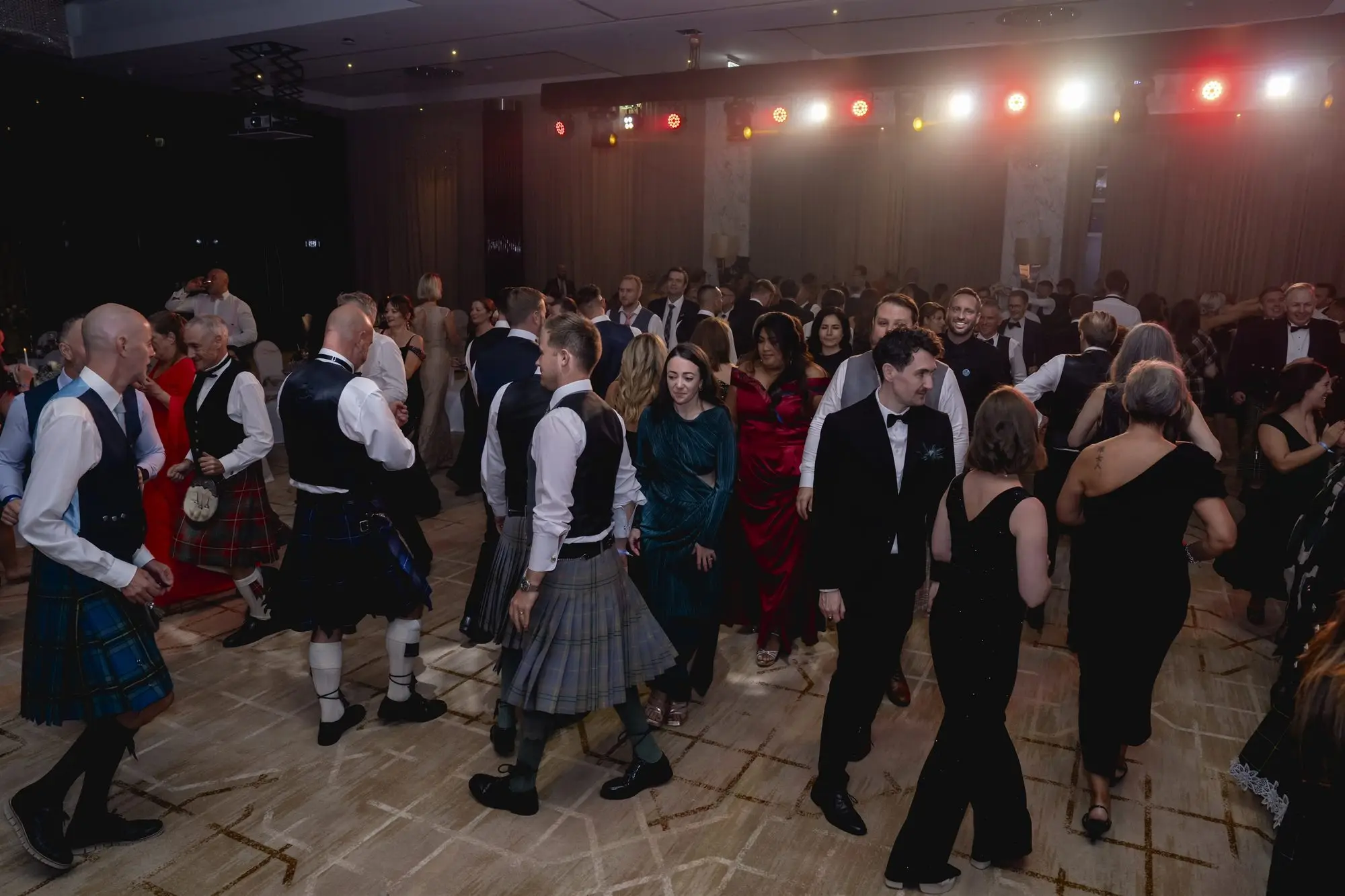 Members dancing in kilts and ball gowns at the St Andrew's Ball 2025